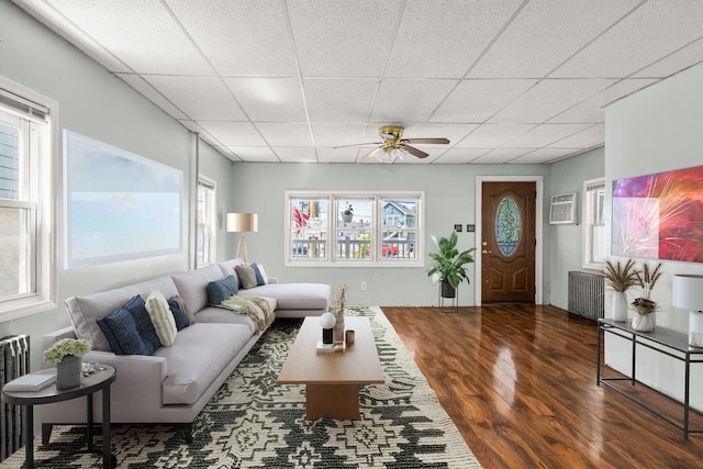 0 Cross Bay Blvd, Broad Channel, NY 11693 - living area with ceiling fan, wood finished floors, a drop ceiling, radiator, and an AC wall unit
