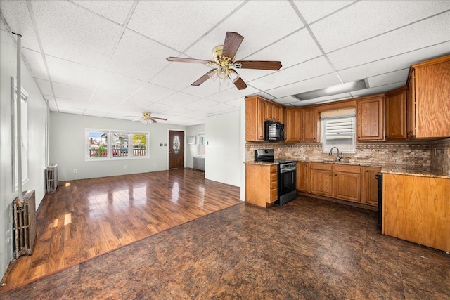 0 Cross Bay Blvd, Broad Channel, NY 11693 - kitchen featuring stainless steel electric range, black microwave, radiator heating unit, a sink, and brown cabinetry