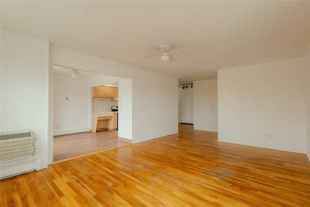8 Florence Ave Unit 16C, Freeport, NY 11520 - unfurnished room featuring a ceiling fan, light wood-style floors, and an AC wall unit