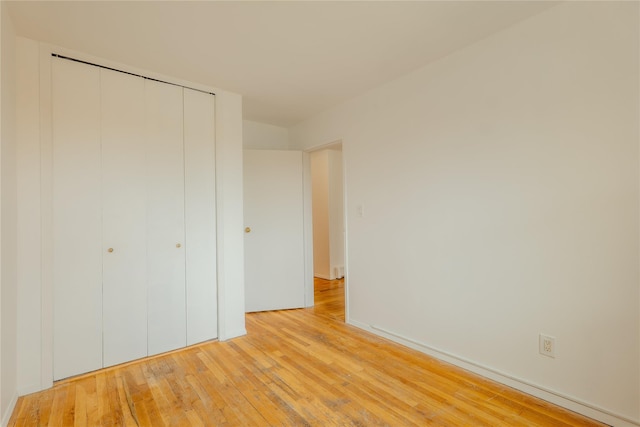 8 Florence Ave Unit 16C, Freeport, NY 11520 - unfurnished bedroom with light wood-type flooring and a closet