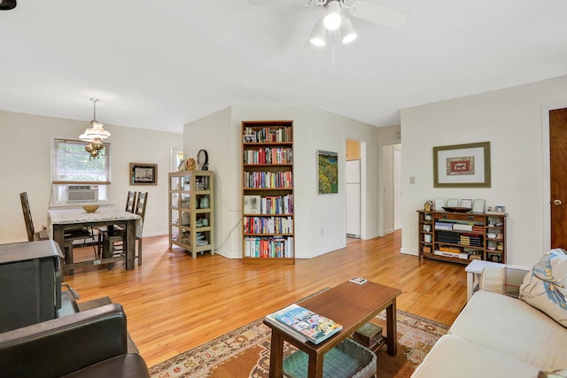 512 Watson Woods Rd, Woodstock, NY 12498 - living room with light wood-type flooring, a ceiling fan, a chandelier, and cooling unit