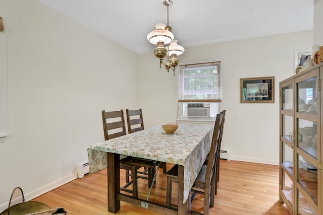 512 Watson Woods Rd, Woodstock, NY 12498 - dining space with cooling unit, light wood finished floors, a baseboard heating unit, a chandelier, and baseboards