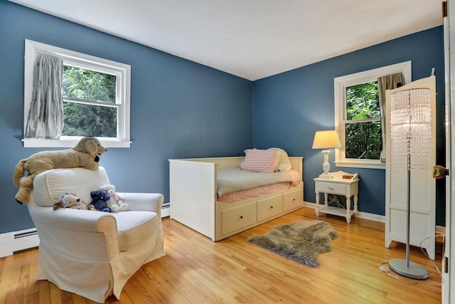 512 Watson Woods Rd, Woodstock, NY 12498 - bedroom with multiple windows, wood finished floors, and baseboard heating