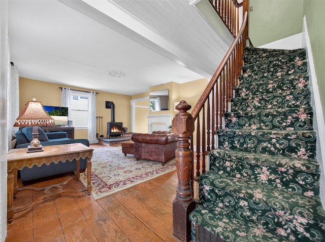 31 Hudson Ave, Stony Point, NY 10980 - living area with stairway, a wood stove, and wood-type flooring