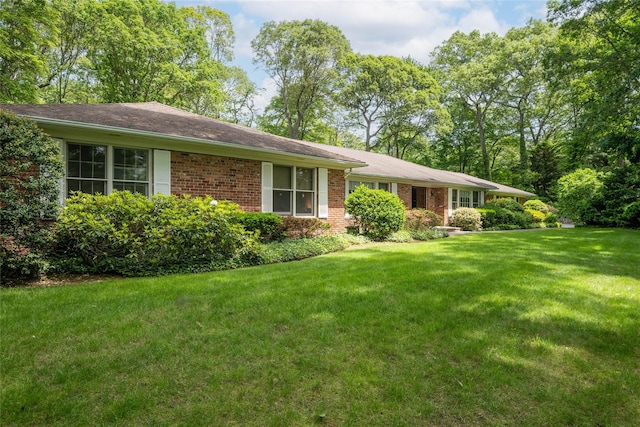 100 Foxhunt Cres, Oyster Bay Cove, NY 11791 - view of front of house featuring brick siding and a front lawn