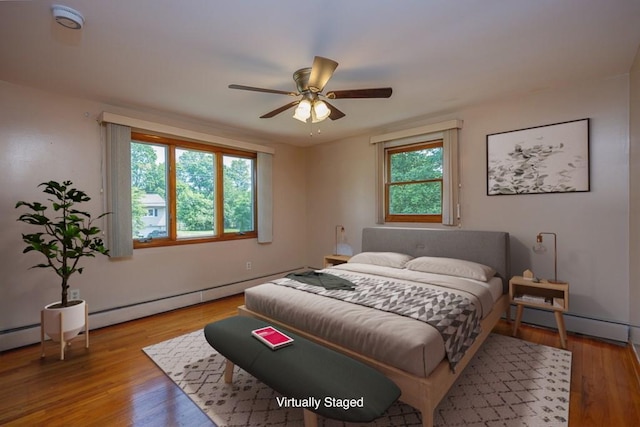 6 Regency Dr, Wappingers Falls, NY 12590 - bedroom featuring wood finished floors, a baseboard heating unit, and ceiling fan