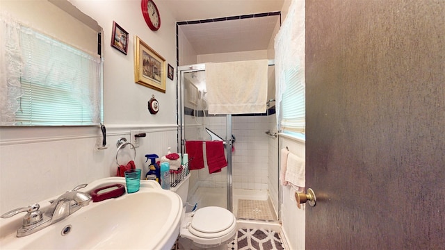 4 Christine Dr, Spring Valley, NY 10977 - bathroom with a sink, toilet, a stall shower, and wainscoting