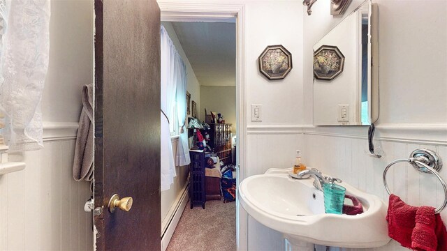 4 Christine Dr, Spring Valley, NY 10977 - bathroom with a wainscoted wall, a baseboard radiator, a sink, and a decorative wall