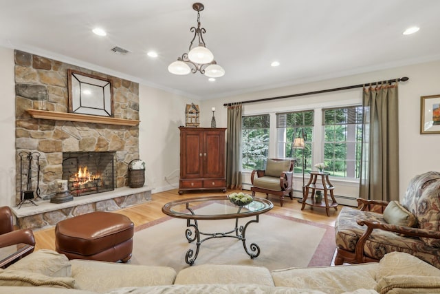 42 Panorama Dr, Warwick, NY 10990 - living area with crown molding, wood finished floors, a stone fireplace, recessed lighting, and baseboard heating