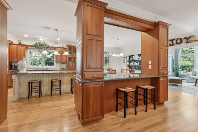 42 Panorama Dr, Warwick, NY 10990 - bar featuring a chandelier, light wood-style flooring, hanging light fixtures, crown molding, and a sink