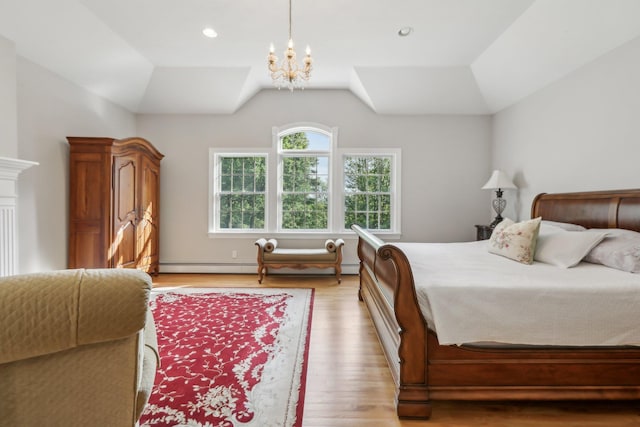 42 Panorama Dr, Warwick, NY 10990 - bedroom with a chandelier, light wood-type flooring, vaulted ceiling, and a baseboard heating unit