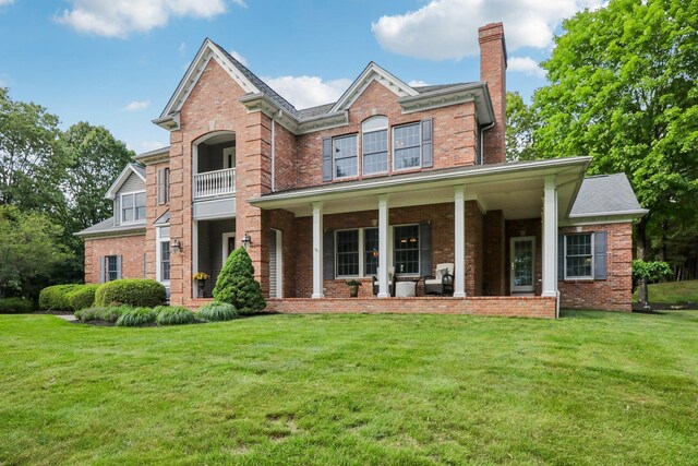 42 Panorama Dr, Warwick, NY 10990 - view of front of house featuring brick siding, a chimney, a front yard, and covered porch