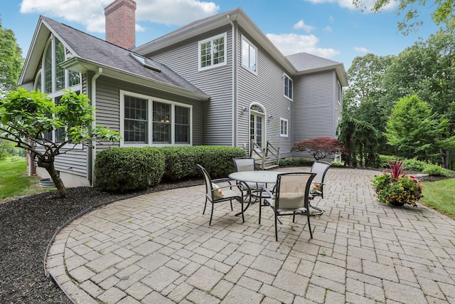 42 Panorama Dr, Warwick, NY 10990 - rear view of house featuring a patio area, a chimney, outdoor dining area, and entry steps