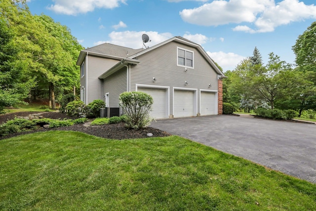 42 Panorama Dr, Warwick, NY 10990 - view of side of property featuring an attached garage, asphalt driveway, and a lawn
