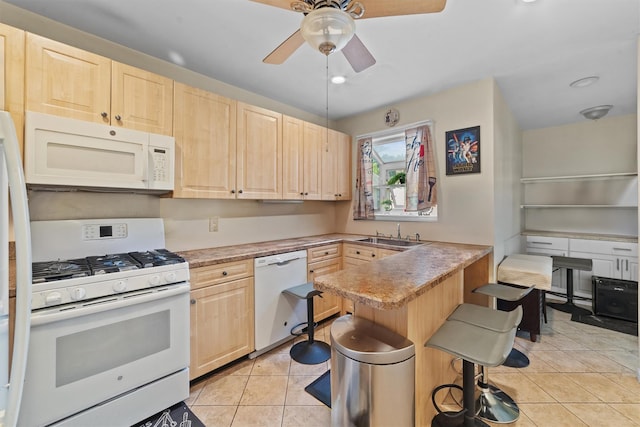 107 Underhill Ave, West Harrison, NY 10604 - kitchen featuring white appliances, light brown cabinets, a kitchen bar, light tile patterned flooring, and a sink