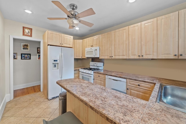 107 Underhill Ave, West Harrison, NY 10604 - kitchen with light brown cabinets, white appliances, a ceiling fan, light tile patterned floors, and baseboards