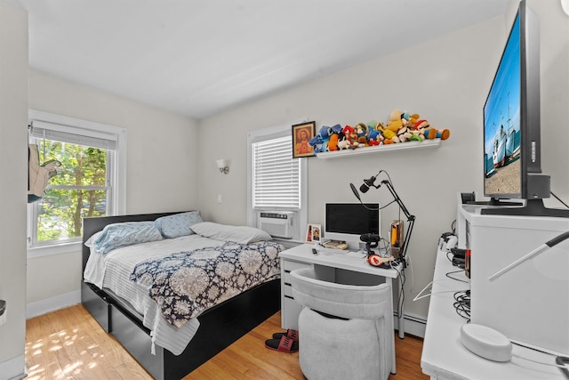 107 Underhill Ave, West Harrison, NY 10604 - bedroom featuring a baseboard radiator, wood finished floors, cooling unit, and baseboards