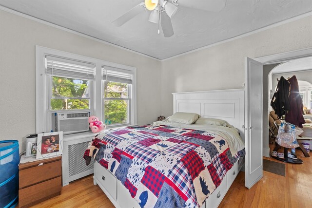 107 Underhill Ave, West Harrison, NY 10604 - bedroom featuring light wood finished floors, crown molding, cooling unit, a ceiling fan, and radiator