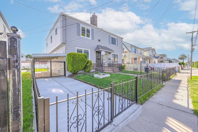 117-07 202nd St, Saint Albans, NY 11412 - view of front facade with a fenced front yard, a residential view, a gate, a chimney, and driveway