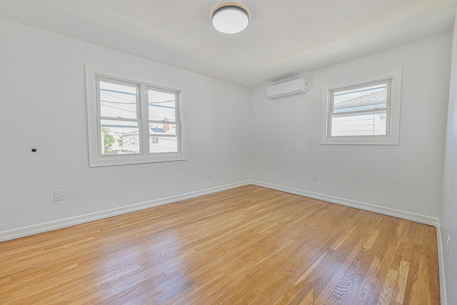 117-07 202nd St, Saint Albans, NY 11412 - unfurnished room with light wood finished floors, baseboards, and a wall unit AC