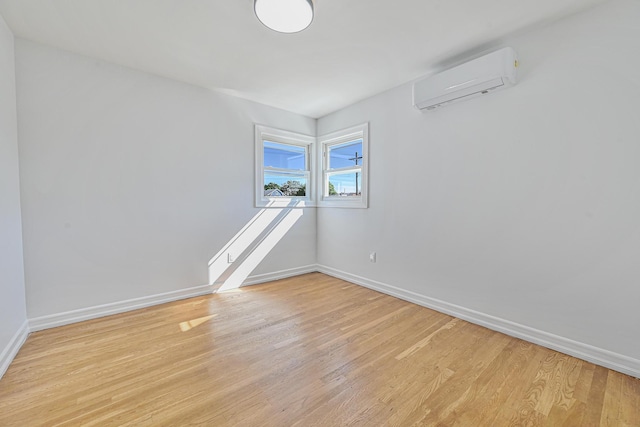 117-07 202nd St, Saint Albans, NY 11412 - empty room featuring a wall mounted air conditioner, baseboards, and light wood-style flooring
