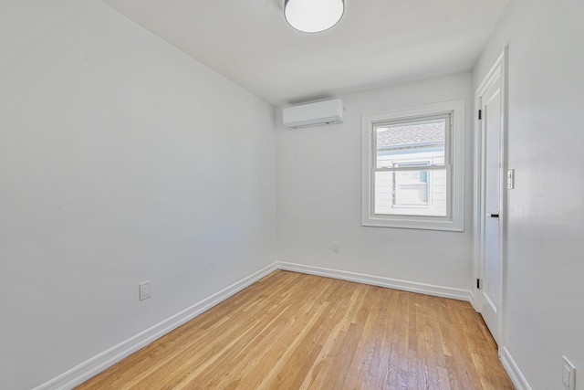 117-07 202nd St, Saint Albans, NY 11412 - unfurnished room with a wall mounted AC, light wood-style floors, and baseboards