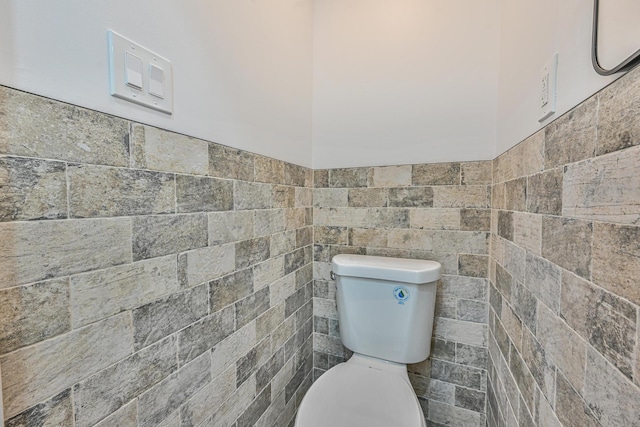 117-07 202nd St, Saint Albans, NY 11412 - bathroom with tile walls, toilet, and wainscoting