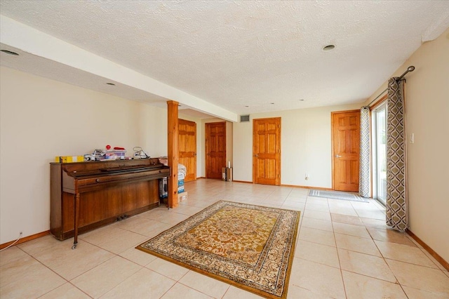 378 W Waukena Ave, Oceanside, NY 11572 - unfurnished room featuring light tile patterned flooring and a textured ceiling