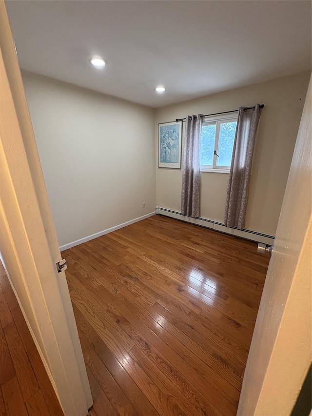 378 W Waukena Ave, Oceanside, NY 11572 - spare room with wood finished floors, baseboard heating, and recessed lighting