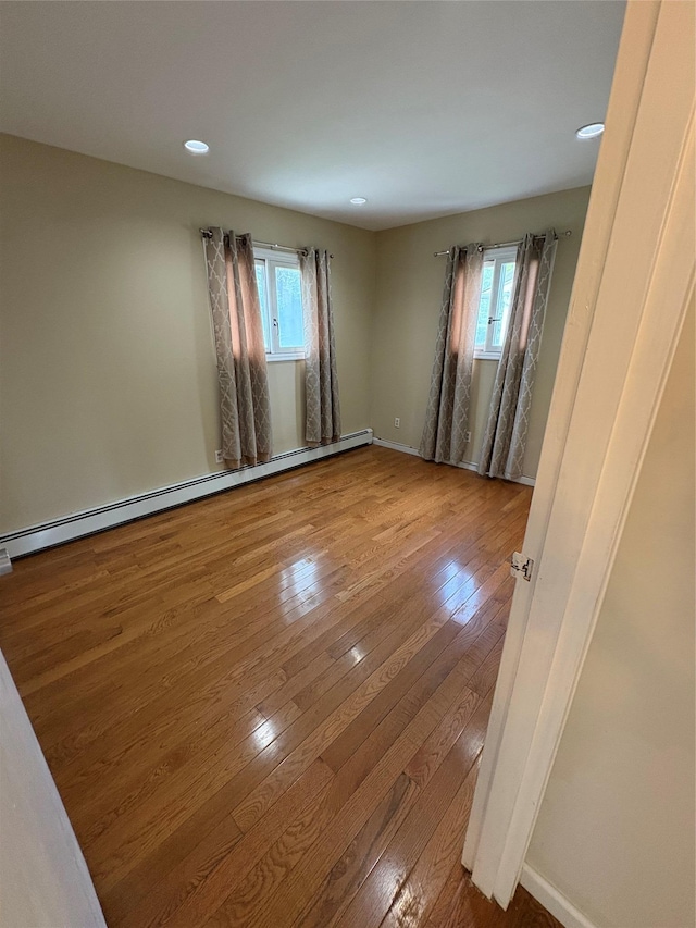 378 W Waukena Ave, Oceanside, NY 11572 - empty room with wood-type flooring, baseboard heating, plenty of natural light, and recessed lighting