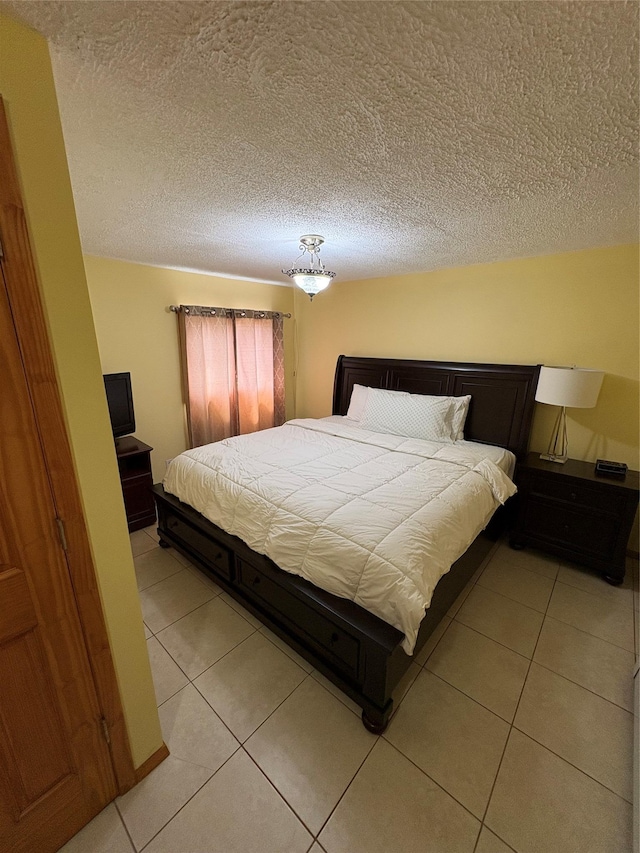 378 W Waukena Ave, Oceanside, NY 11572 - bedroom with light tile patterned floors and a textured ceiling