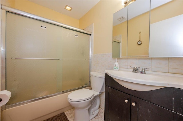 378 W Waukena Ave, Oceanside, NY 11572 - full bath featuring vanity, combined bath / shower with glass door, tile patterned flooring, tile walls, and a wainscoted wall