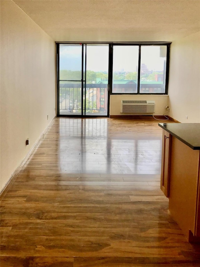 150-38 Union Tpke Unit 4D, Flushing, NY 11367 - spare room featuring wood finished floors, expansive windows, and a wall mounted AC