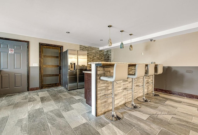 150-38 Union Tpke Unit 4D, Flushing, NY 11367 - kitchen with stainless steel fridge with ice dispenser, a kitchen breakfast bar, light countertops, pendant lighting, and a peninsula