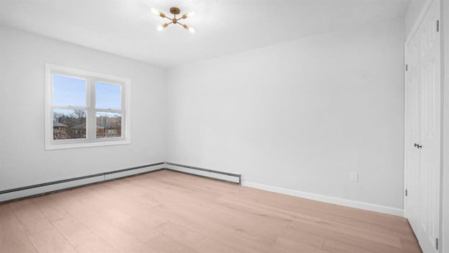 3412 Kingsland Ave, Bronx, NY 10469 - empty room featuring light wood finished floors, a chandelier, and baseboards