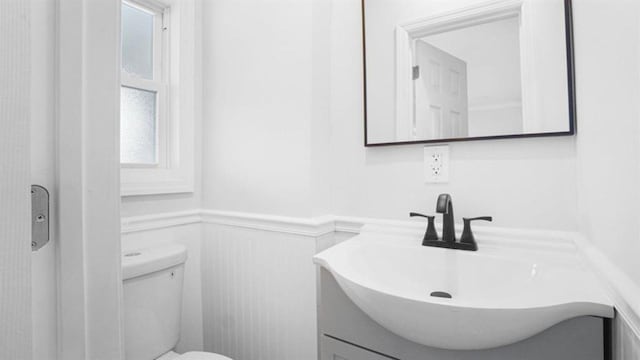 3412 Kingsland Ave, Bronx, NY 10469 - bathroom featuring vanity, toilet, and wainscoting