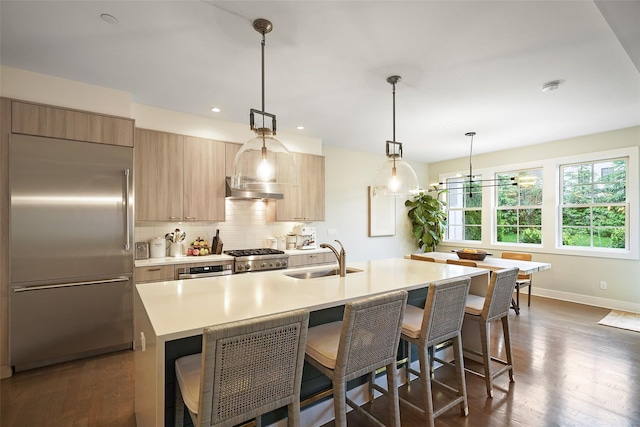 5 Rose Ln, Rye Brook, NY 10573 - kitchen featuring stainless steel built in refrigerator, a sink, light countertops, a breakfast bar, and modern cabinets