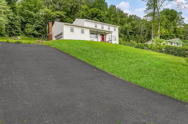 41 W Gate Rd, Suffern, NY 10901 - view of front of house with a front yard, driveway, a porch, a garage, and a chimney