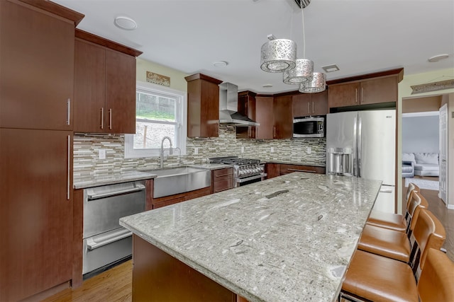 41 W Gate Rd, Suffern, NY 10901 - kitchen featuring a sink, stainless steel appliances, wall chimney range hood, tasteful backsplash, and light stone counters