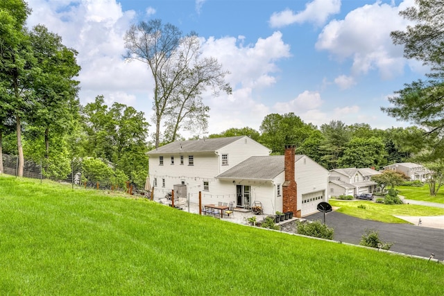 41 W Gate Rd, Suffern, NY 10901 - rear view of property with an attached garage, a yard, driveway, and a chimney