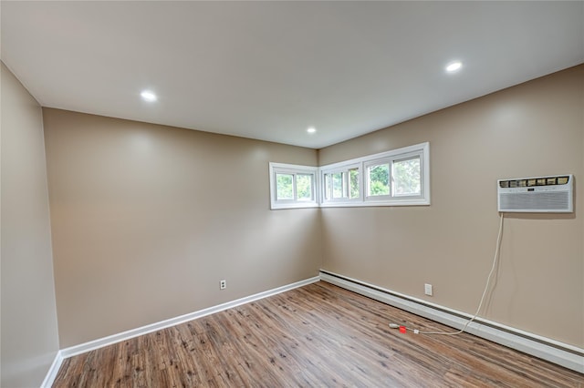 51 Franklin St, Brentwood, NY 11717 - unfurnished room with a baseboard radiator, a wall mounted AC, baseboards, wood finished floors, and recessed lighting