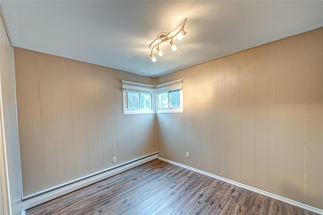 51 Franklin St, Brentwood, NY 11717 - unfurnished room with wood finished floors and a baseboard radiator