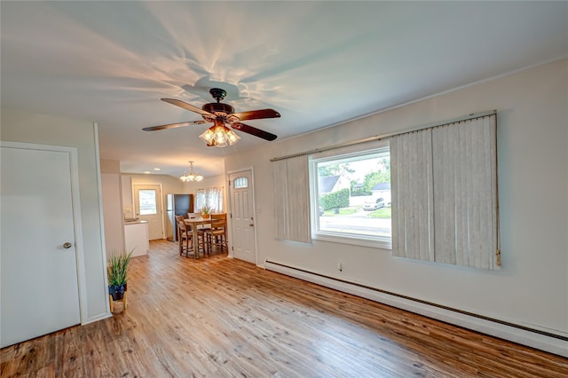 51 Franklin St, Brentwood, NY 11717 - unfurnished living room with a baseboard radiator, wood finished floors, a ceiling fan, and a chandelier