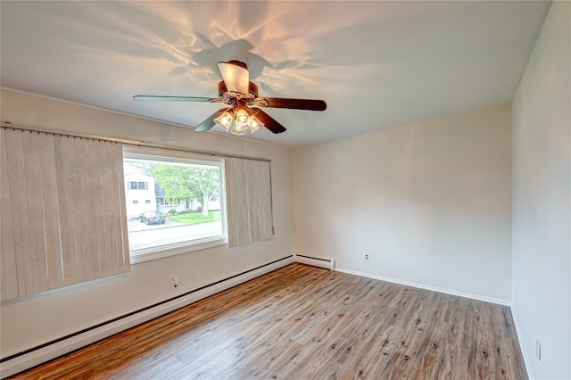 51 Franklin St, Brentwood, NY 11717 - unfurnished room featuring a baseboard heating unit, wood finished floors, ceiling fan, and baseboards