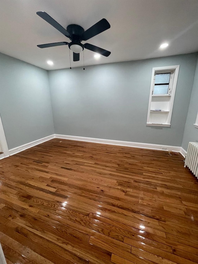 70-31 71st Pl, Glendale, NY 11385 - unfurnished room featuring dark wood-style floors, a ceiling fan, radiator heating unit, baseboards, and recessed lighting