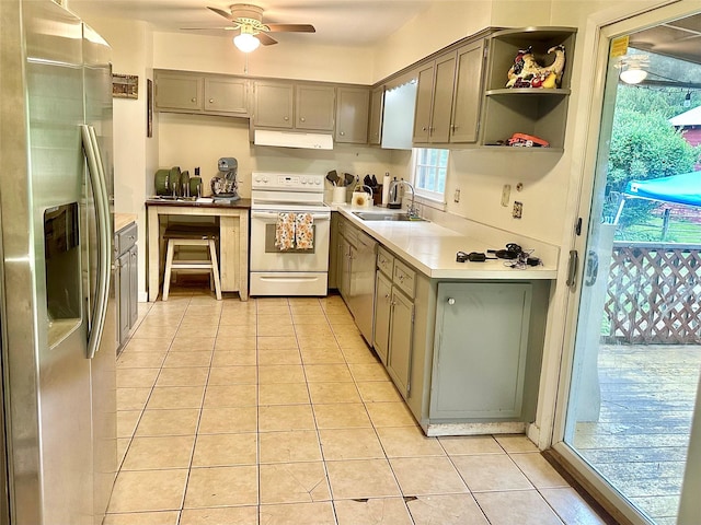 5646 Rte 82, Clinton Corners, NY 12514 - kitchen featuring stainless steel fridge, white range with electric cooktop, a sink, light tile patterned floors, and under cabinet range hood