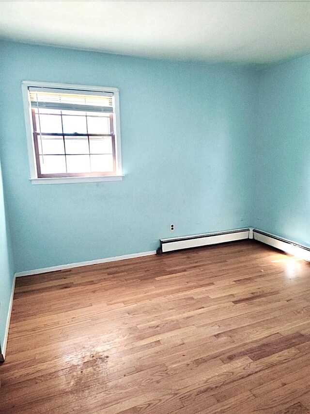 5646 Rte 82, Clinton Corners, NY 12514 - unfurnished room with wood finished floors, baseboards, and a baseboard radiator