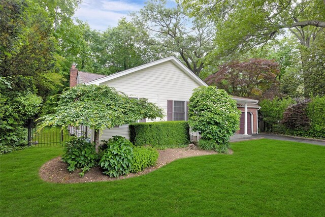 64 Church St, Syosset, NY 11791 - view of home's exterior with a lawn, a chimney, and driveway