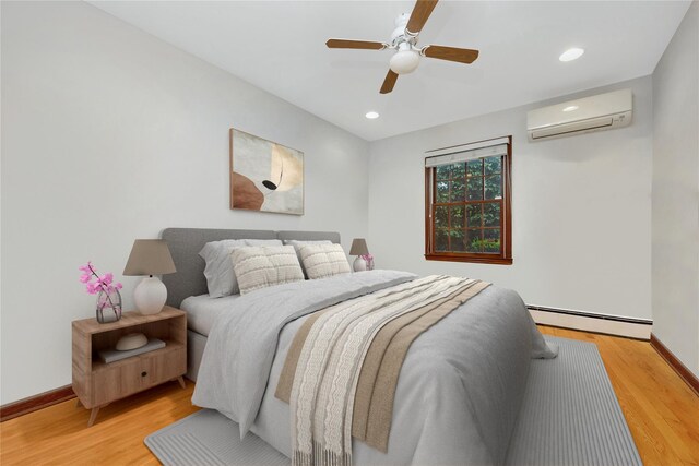 64 Church St, Syosset, NY 11791 - bedroom featuring a wall unit AC, a baseboard radiator, baseboards, light wood-type flooring, and recessed lighting