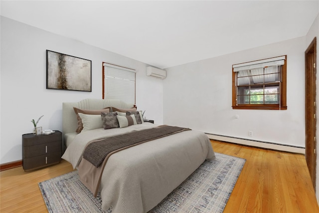 64 Church St, Syosset, NY 11791 - bedroom featuring a baseboard radiator, a wall mounted air conditioner, light wood-type flooring, and baseboards